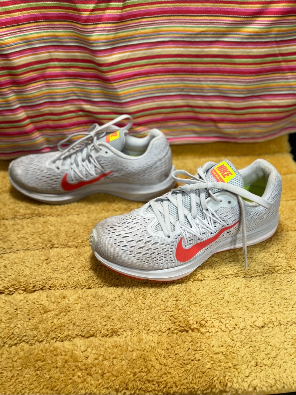 Nike Light Gray Running Shoes with Red Swoosh and Neon Yellow Accents